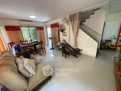 Spacious living room with modern decor and staircase in a cozy home