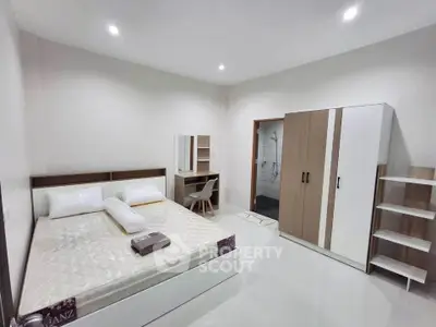 Spacious modern bedroom with sleek furniture and ensuite bathroom