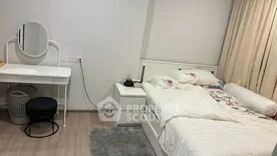 Cozy bedroom with modern white furniture and stylish vanity desk, perfect for relaxation and comfort.