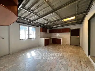 Spacious kitchen with rustic tile flooring and ample natural light