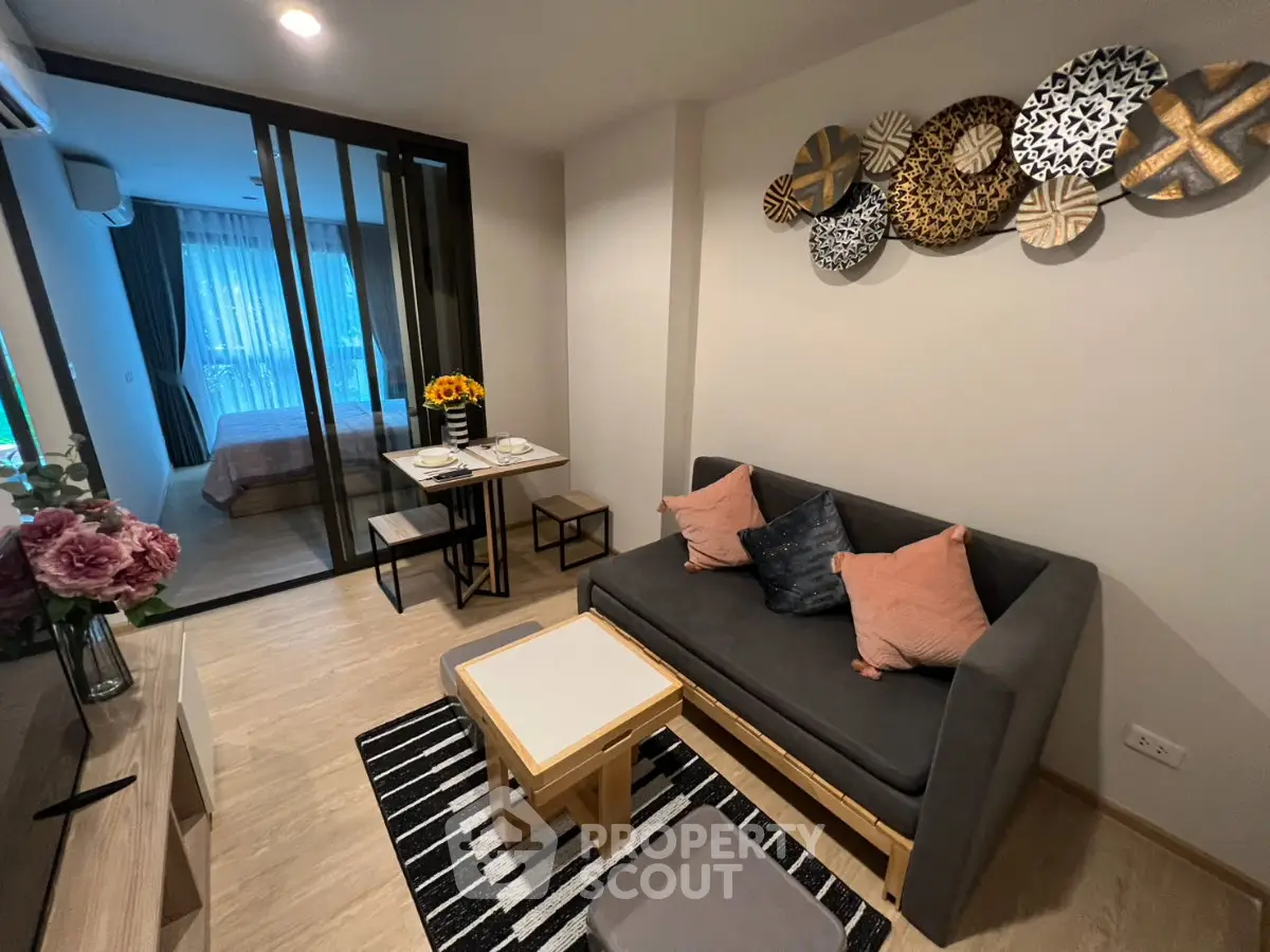Modern living room with stylish decor and open view to bedroom, perfect for cozy urban living.