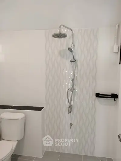 Modern bathroom with sleek shower design and elegant tile work.