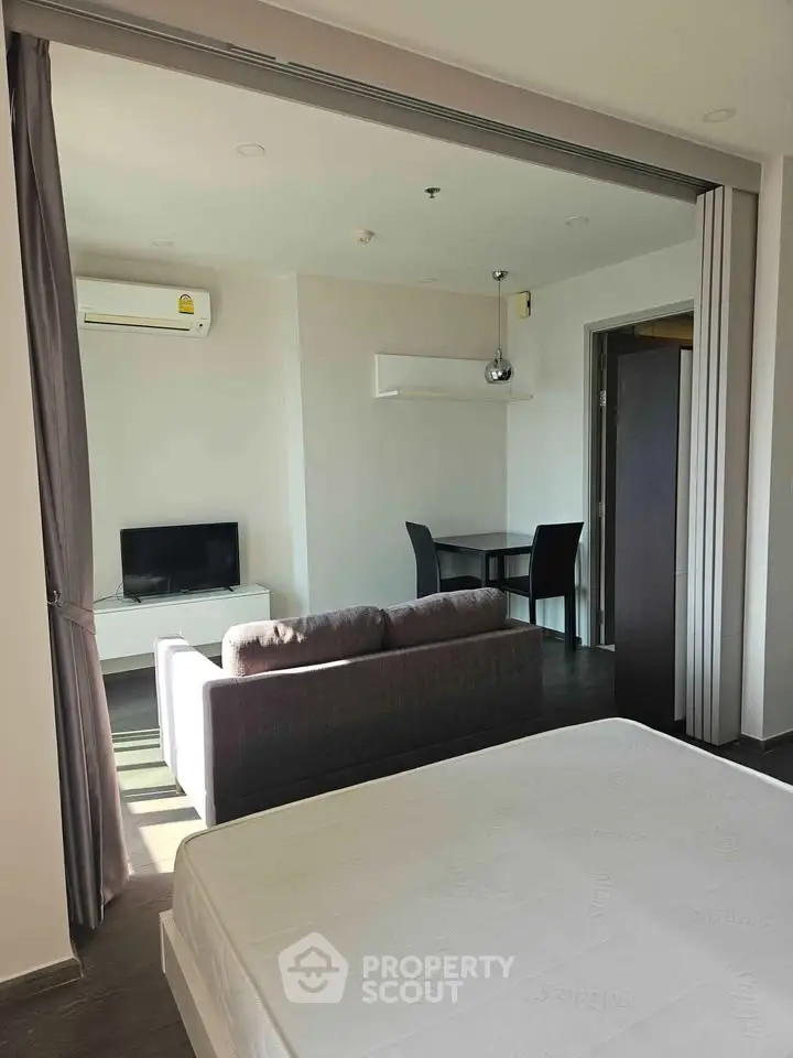 Modern studio apartment with open layout, featuring a cozy living area and dining space, perfect for urban living.