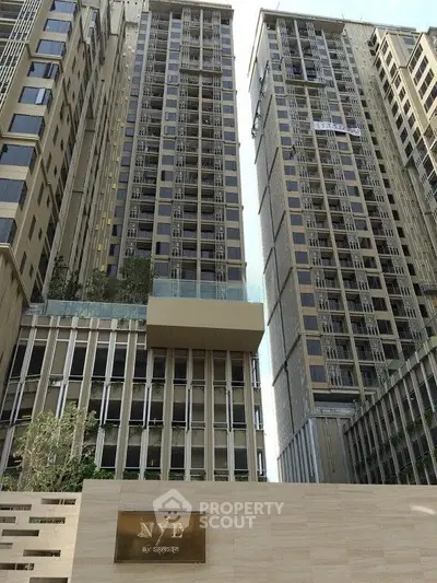 Luxurious high-rise building with modern architecture and elegant facade in urban setting.