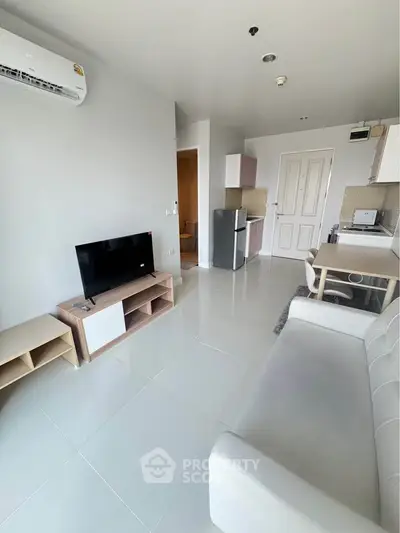 Modern living room with sleek furniture and compact kitchen area