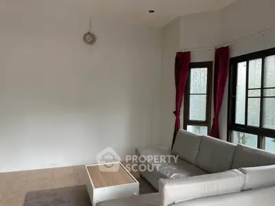 Spacious living room with modern sofa and large windows for natural light