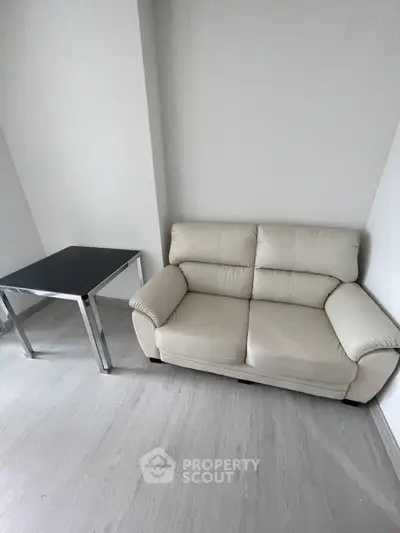 Minimalist living room with modern sofa and sleek table, perfect for urban living.