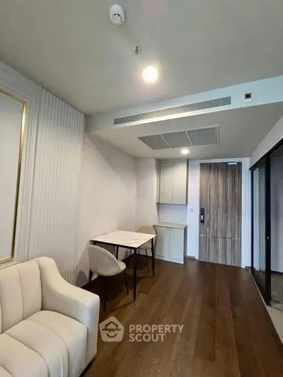 Modern living room with elegant decor and wooden flooring in a stylish apartment.