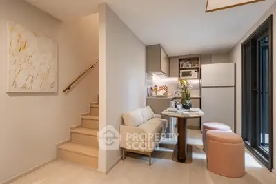 Modern compact kitchen with cozy dining area and staircase in stylish apartment