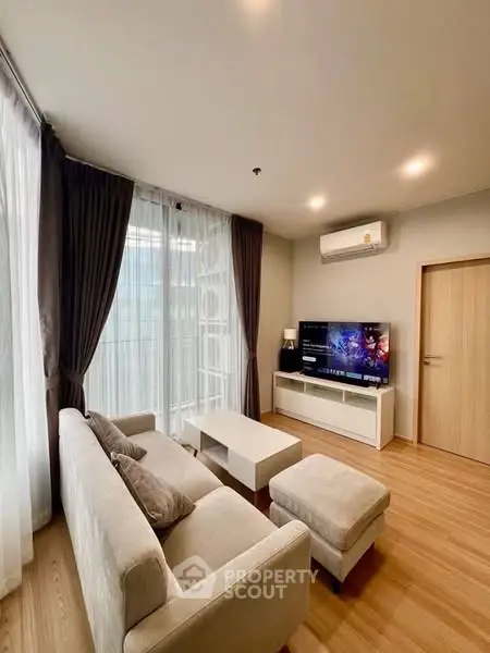 Modern living room with cozy sofa and entertainment center in a bright apartment.
