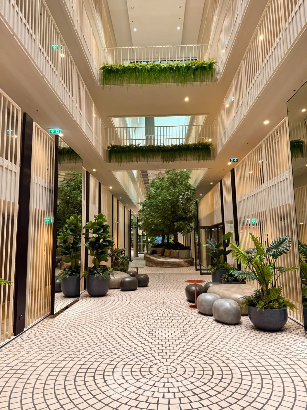 Luxurious modern building entrance with lush greenery and elegant design