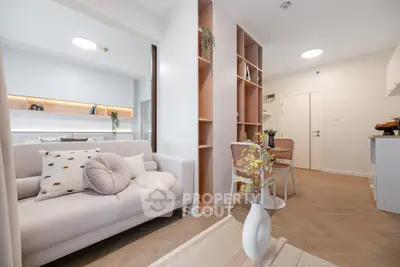 Modern living room with cozy seating and stylish decor in a bright apartment.