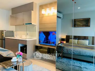 Modern studio apartment with sleek kitchen and cozy bedroom area