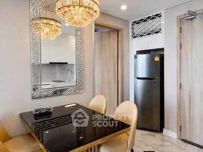 Elegant dining area with modern chandelier and sleek kitchen view