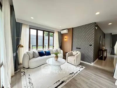 Elegant living room with modern decor, large windows, and stylish furniture in a bright, airy space.