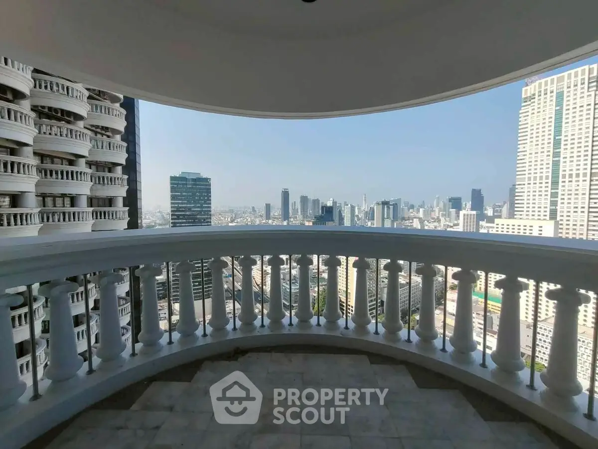 Stunning cityscape view from a spacious balcony in a high-rise building.