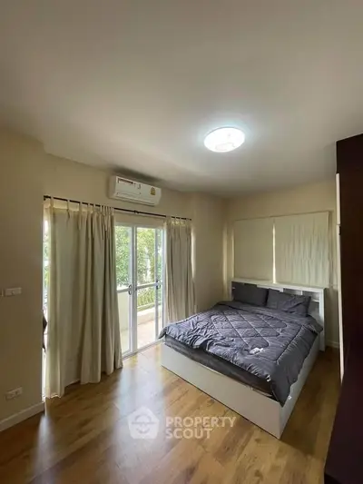 Cozy bedroom with balcony access and modern decor