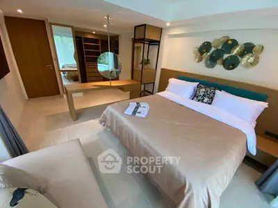 Modern bedroom with stylish decor and spacious layout, featuring a cozy bed and elegant furnishings.