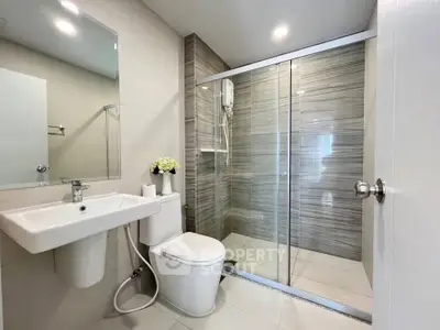 Modern bathroom with sleek shower and elegant fixtures in a contemporary home.