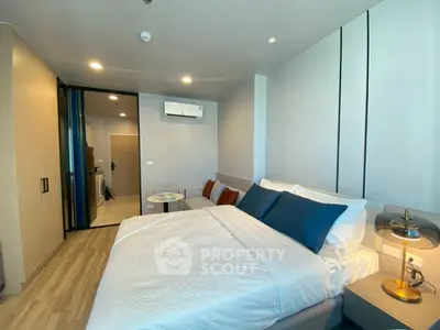 Modern bedroom with stylish decor and air conditioning in a contemporary apartment.