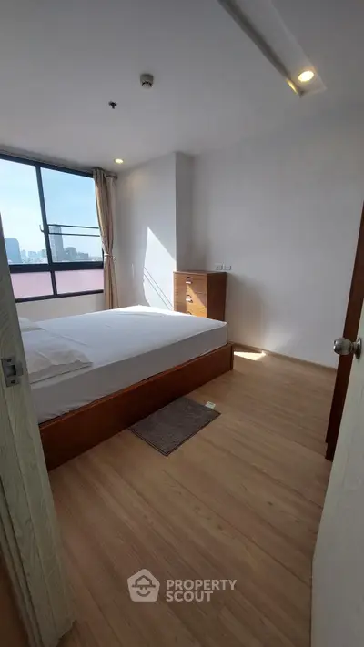 Bright and airy bedroom with city view and modern furnishings