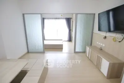 Modern living room with sliding glass doors and wall-mounted TV