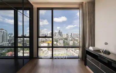 Stunning city view from modern apartment with floor-to-ceiling windows and sleek interior design.
