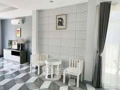 Stylish modern living room with geometric floor tiles and elegant furniture.