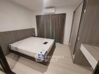Modern bedroom with sleek design, featuring a comfortable bed and stylish wardrobe, perfect for urban living.