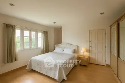 Spacious bedroom with elegant decor and natural light