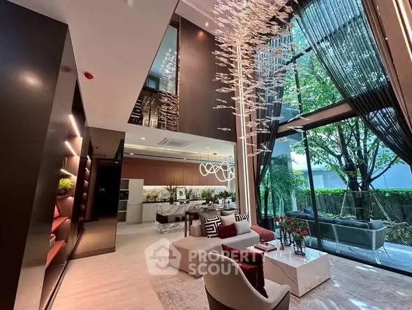 Luxurious modern living room with high ceilings and large windows overlooking a garden.