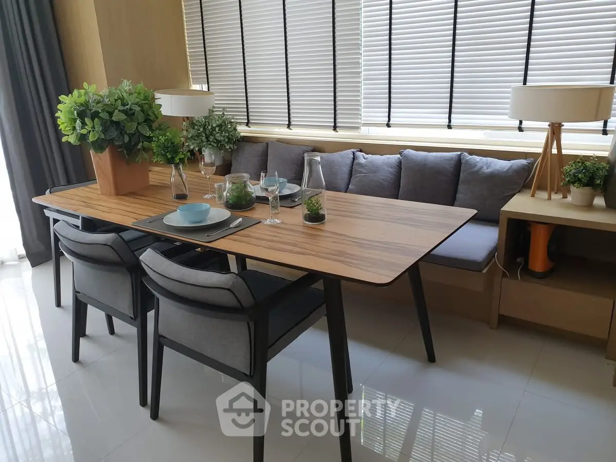 Modern dining area with stylish table, chairs, and decorative plants