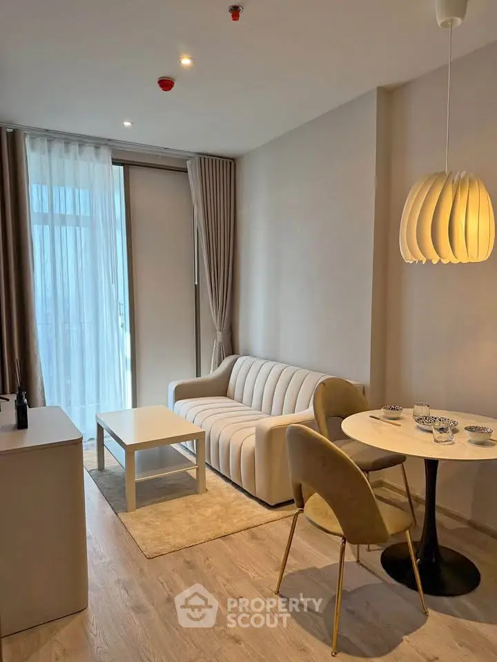 Modern living room with elegant decor and natural light in a stylish apartment.