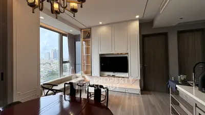 Elegant living room with city view, featuring modern decor and large windows for natural light.