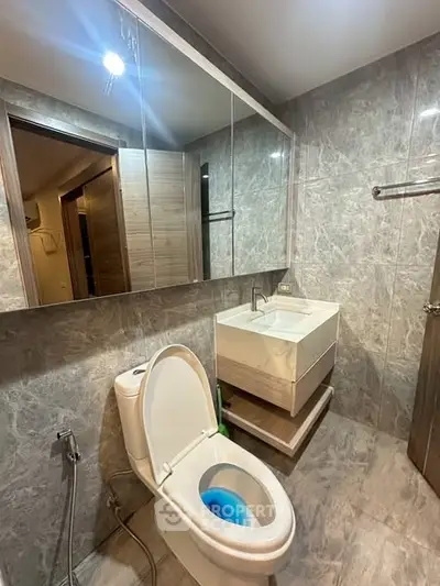 Modern bathroom with sleek design and wall-mounted sink in a stylish apartment.