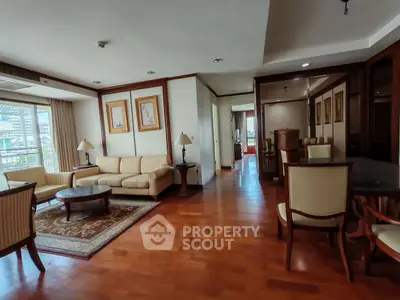 Spacious living room with elegant furniture and wooden flooring, perfect for relaxation and entertaining.