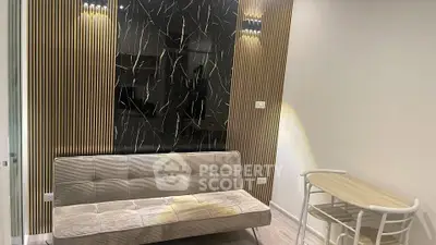Modern living room with stylish sofa and chic wall design, perfect for urban living.
