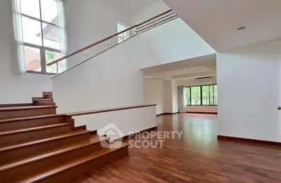 Spacious modern interior with wooden floors and large windows