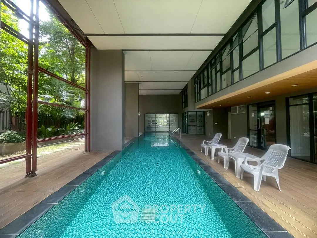 Luxurious indoor pool with modern design and relaxing lounge chairs