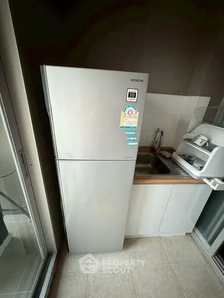 Modern kitchen with sleek refrigerator and compact sink area