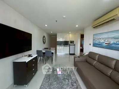 Modern living room with sleek furniture and open kitchen layout in a stylish apartment.