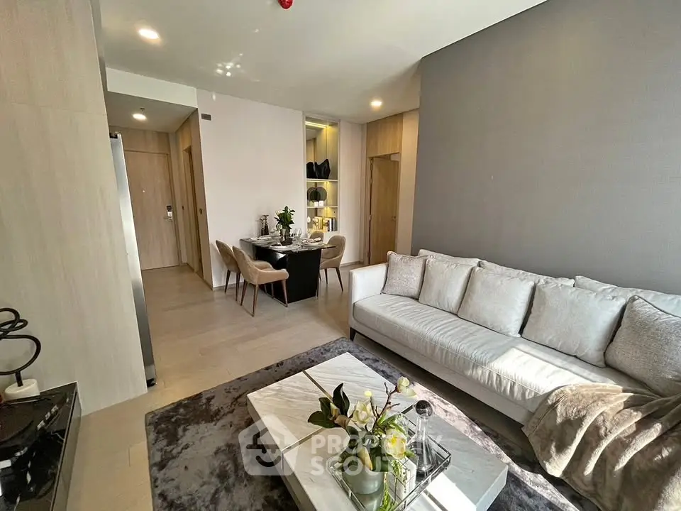 Modern living room with elegant decor and dining area, featuring a cozy sofa and stylish table.