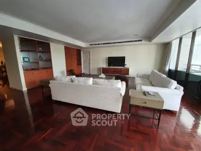 Spacious living room with elegant wooden flooring and modern furniture