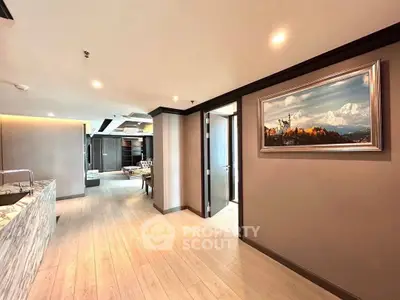 Spacious modern living area with elegant decor and open layout, featuring a stunning wall painting.