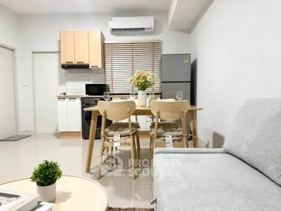 Modern open-plan kitchen and living area with stylish furniture and appliances.