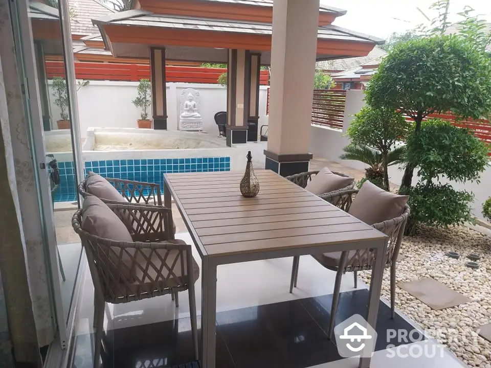 Luxurious patio with pool view and stylish outdoor furniture in serene setting