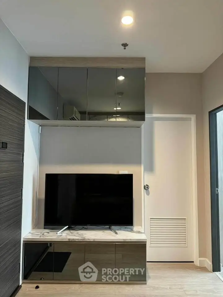 Modern living room with sleek TV setup and stylish storage cabinets