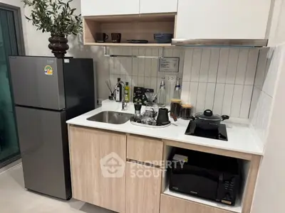 Modern compact kitchen with sleek appliances and stylish cabinetry