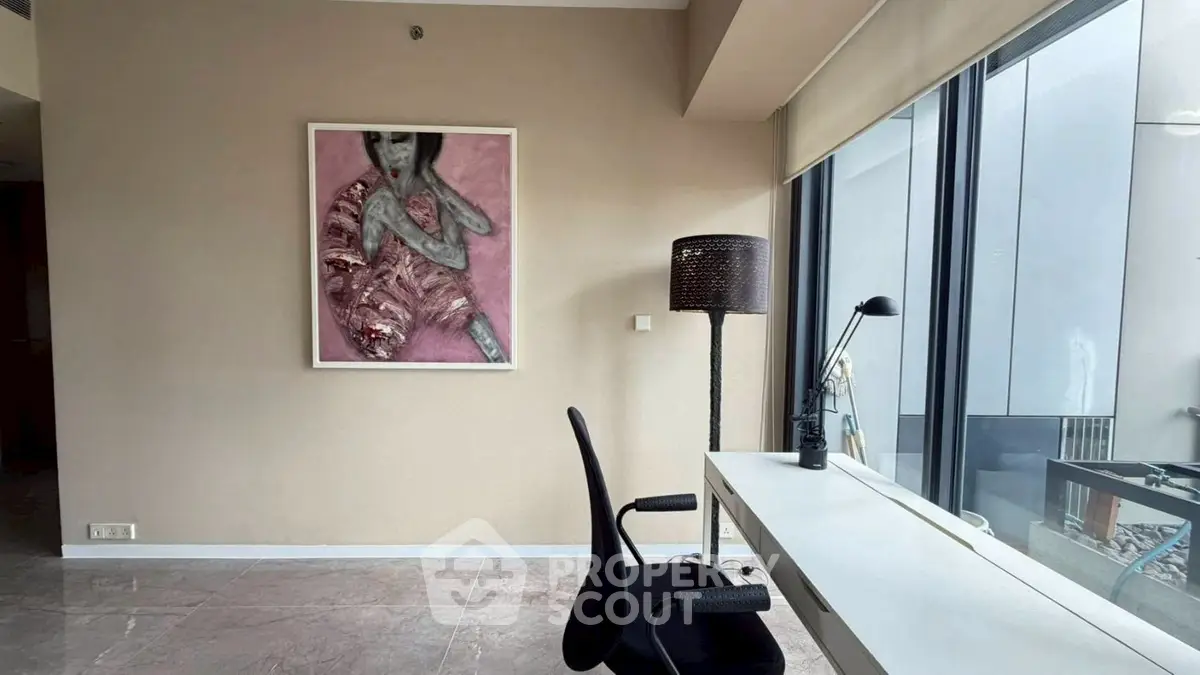 Modern study room with large window and stylish decor in urban apartment.
