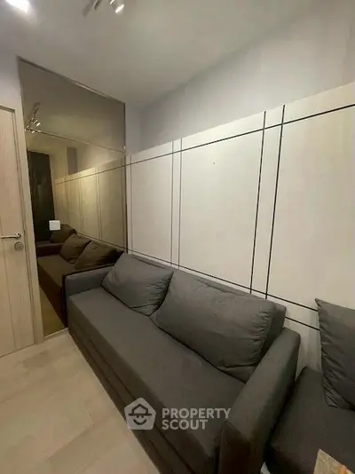 Modern living room with sleek design and comfortable gray sofa